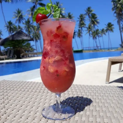 red-drink-table-against-swimming